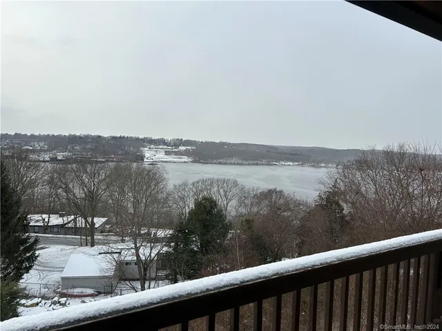a balcony with wooden floor and city view
