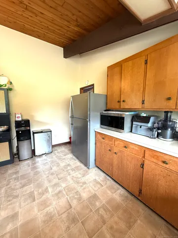a kitchen with refrigerator and cabinets