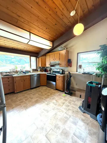 a kitchen with stainless steel appliances granite countertop a sink and cabinets