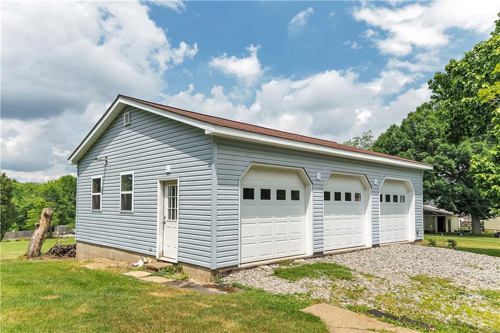 Wonderful 3 car detached heated garage -- The garage features 8-foot doors, plumbing for a restroom, windows for natural lighting, attic storage, 100-amp service, RV hook-up, and an additional window a/c unit for all season comfort.