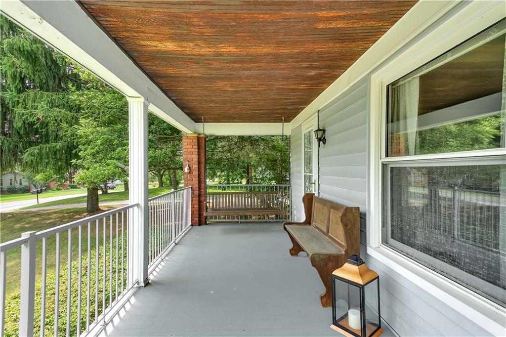 Delightful covered front porch, complete with swing.