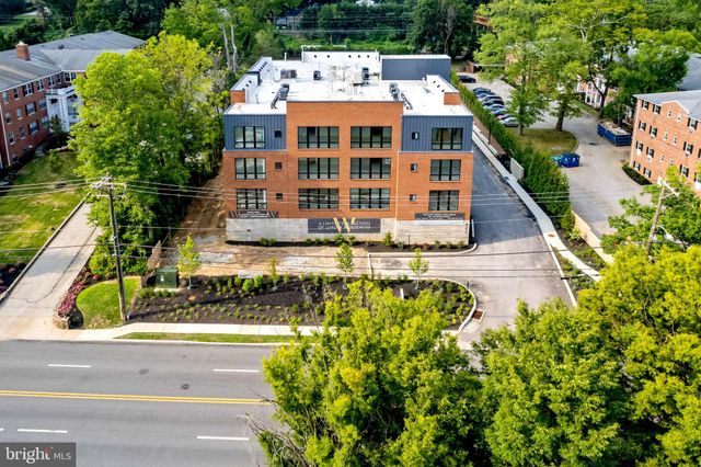 an aerial view of a house with a large trees