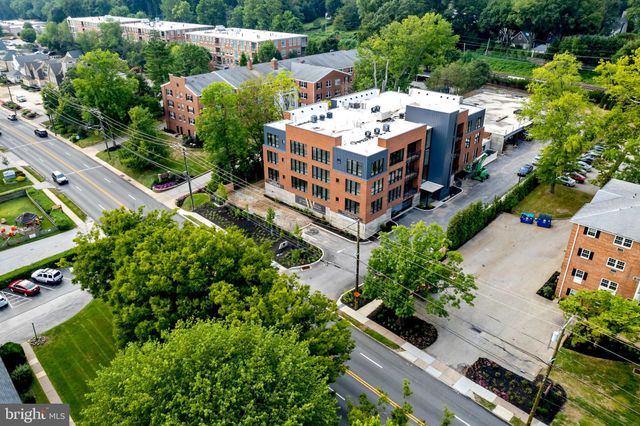 an aerial view of a house with a yard potted plants and large trees