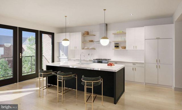 a kitchen with kitchen island a sink a stove a refrigerator and white cabinets
