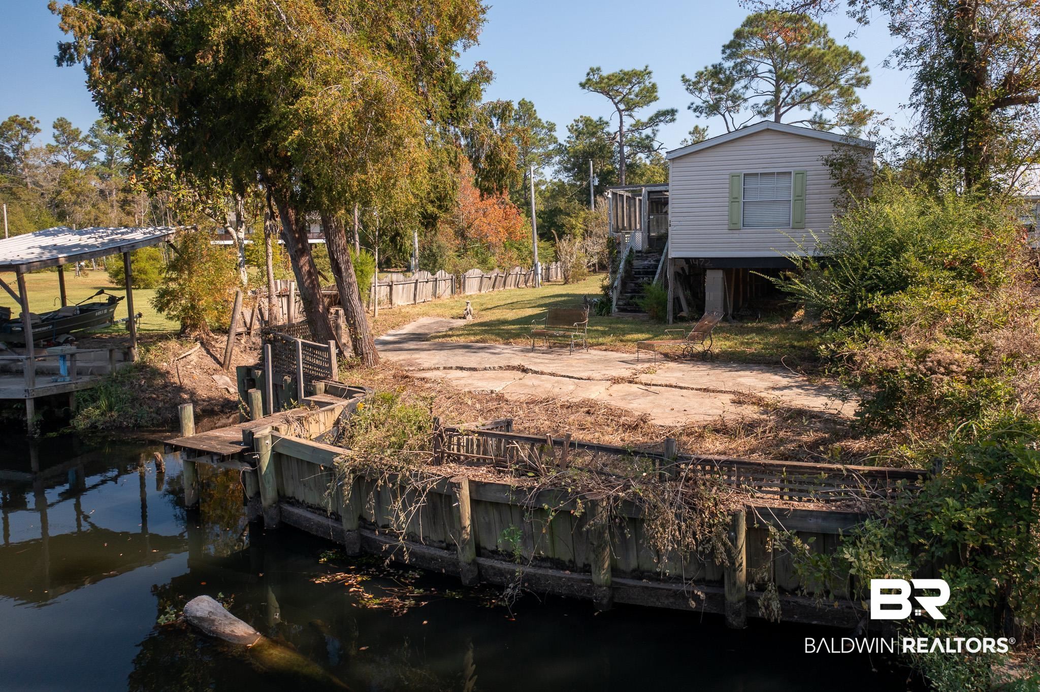 17855 Kingway Road Seminole, AL 36574 - Photo 10 of 20 View of yard with a water view and a dock