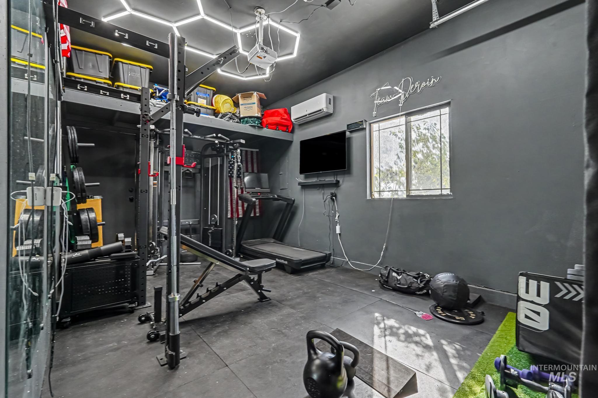 2340 South Alaska Way Meridian, ID 83642 - Photo 41 of 48 Integrated wall shelving with storage, ceiling-mounted hexagonal lighting, window with security bars, and wall-mounted air conditioning unit