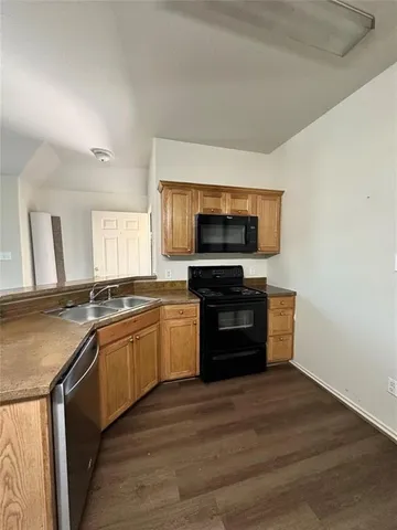 a kitchen with stainless steel appliances granite countertop a stove and a microwave