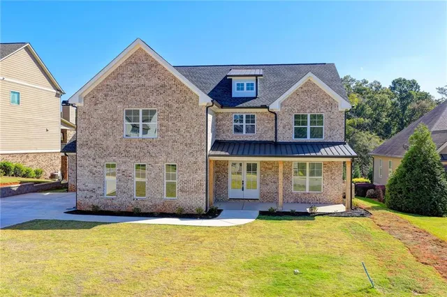 a front view of a house with a yard