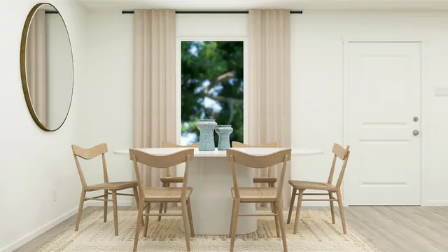 a view of a dining room with furniture and a window