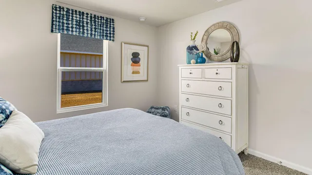 a bedroom with a bed and a dresser