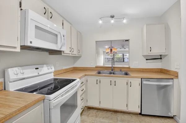 a kitchen with a refrigerator and washer