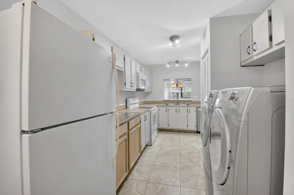 a kitchen with cabinets appliances and a window