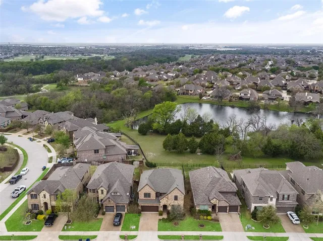 an aerial view of residential houses with outdoor space and river