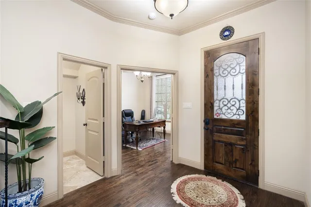 a view of hall way with furniture and wooden floor