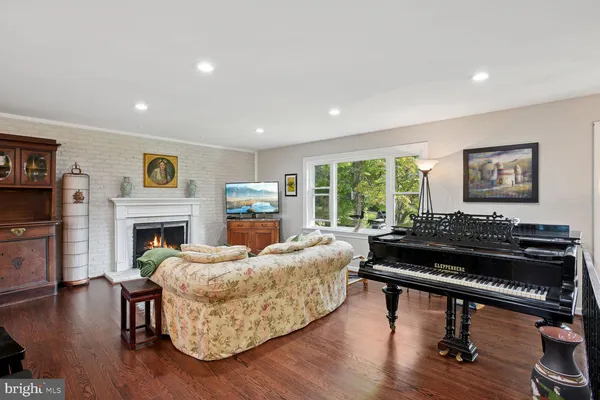 a living room with furniture fireplace and flat screen tv