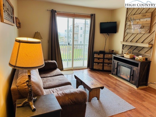 301 Pinnacle Inn Road, Unit 4301 Beech Mountain, NC 28604 - Photo 6 of 9 a living room with furniture and a fireplace