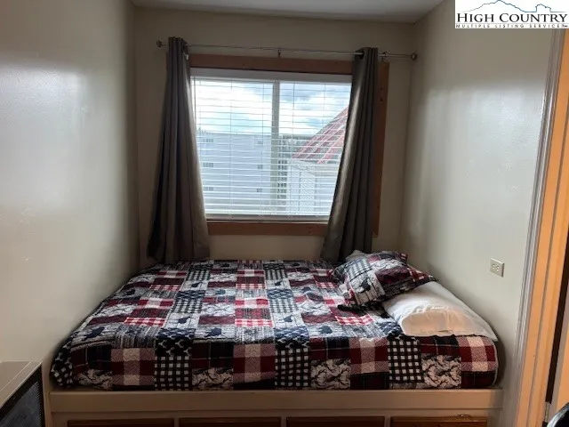 a room with window and rug