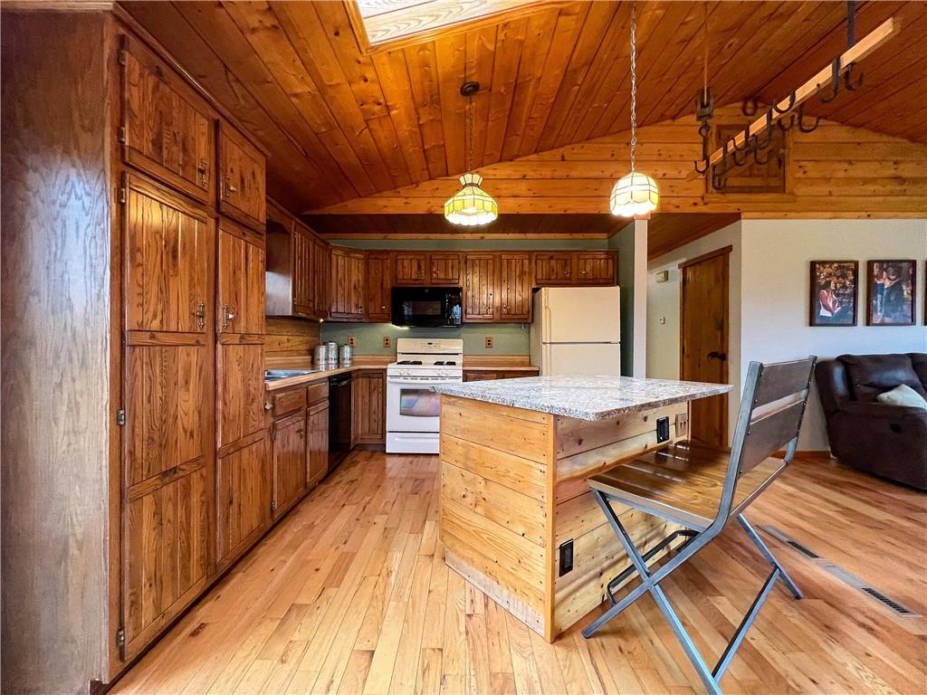 110 Zetta Lane Butler, PA 16002 - Photo 11 of 36 a kitchen with stainless steel appliances granite countertop a stove top oven a sink dishwasher a dining table and chairs with wooden floor