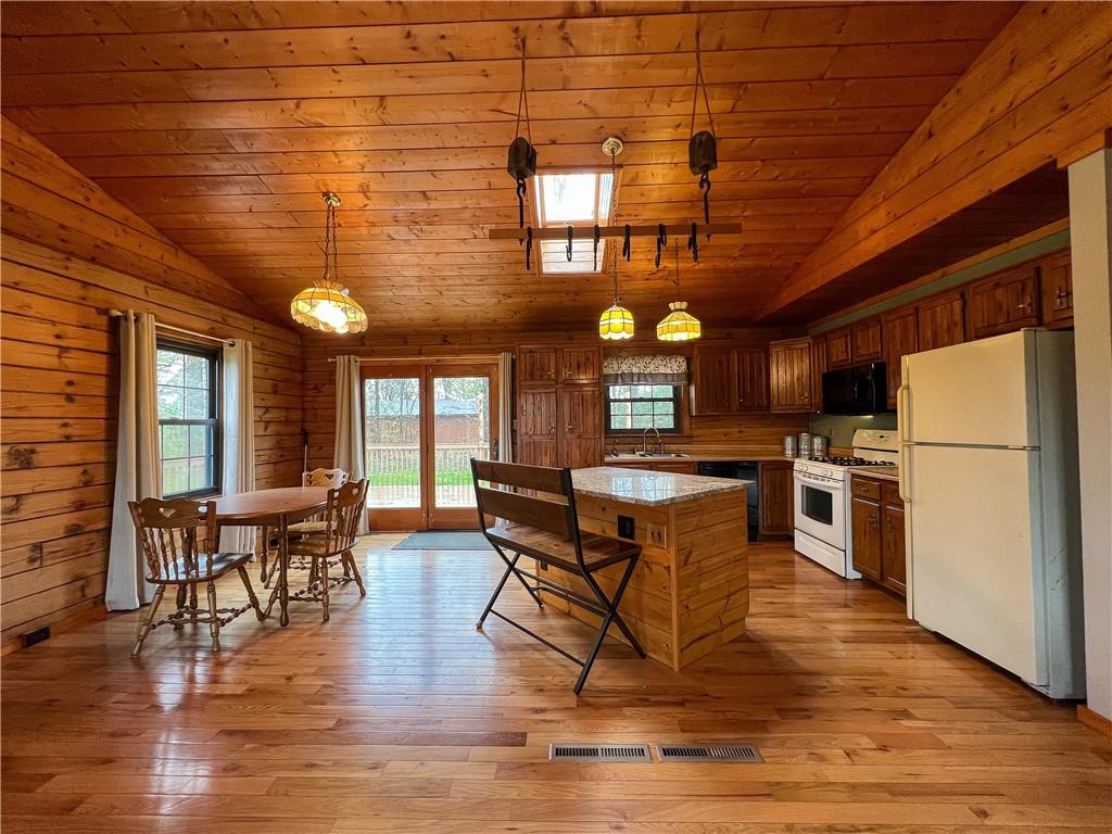 110 Zetta Lane Butler, PA 16002 - Photo 7 of 36 a open kitchen with stainless steel appliances granite countertop a stove a refrigerator a dining table and chairs with wooden floor