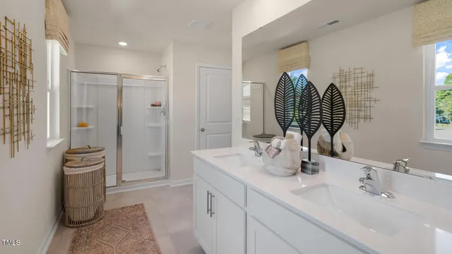 a bathroom with double vanity sink and mirror