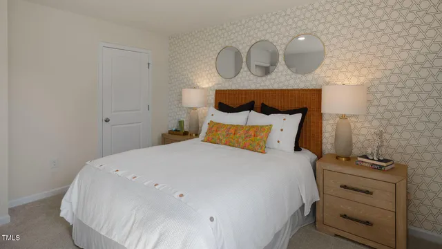 a bedroom with a bed and a wall painting