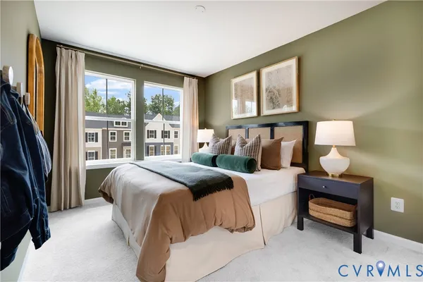 a bedroom with a bed and a large window