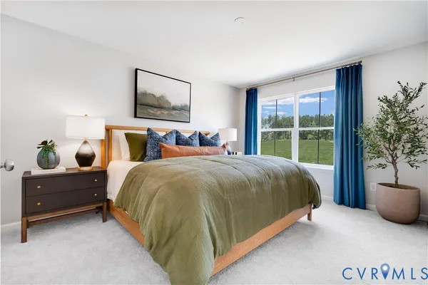 a spacious bedroom with a bed and a potted plant