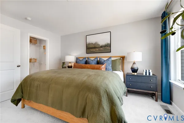 a bedroom with a bed and window