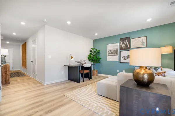 a living room with furniture and a potted plant