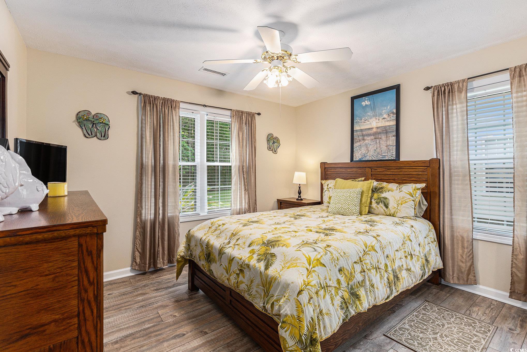 1105 Lampwick Lane Murrells Inlet, SC 29576 - Photo 24 of 40 Bedroom featuring wood finished floors, baseboards, and a ceiling fan