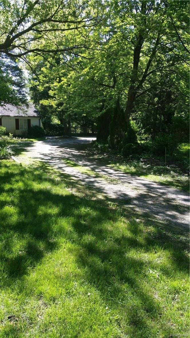1870 Decker Road Walled Lake, MI 48390 - Photo 4 of 60 A long circular driveway with enough parking for over twenty cars