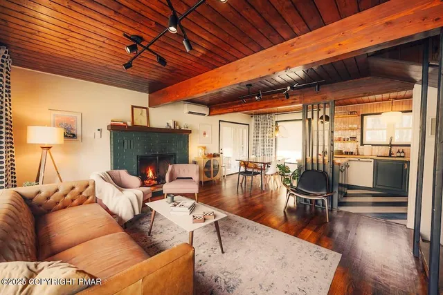 a living room with fireplace furniture and a wooden floor