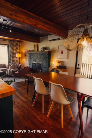 a dining room with furniture and wooden floor