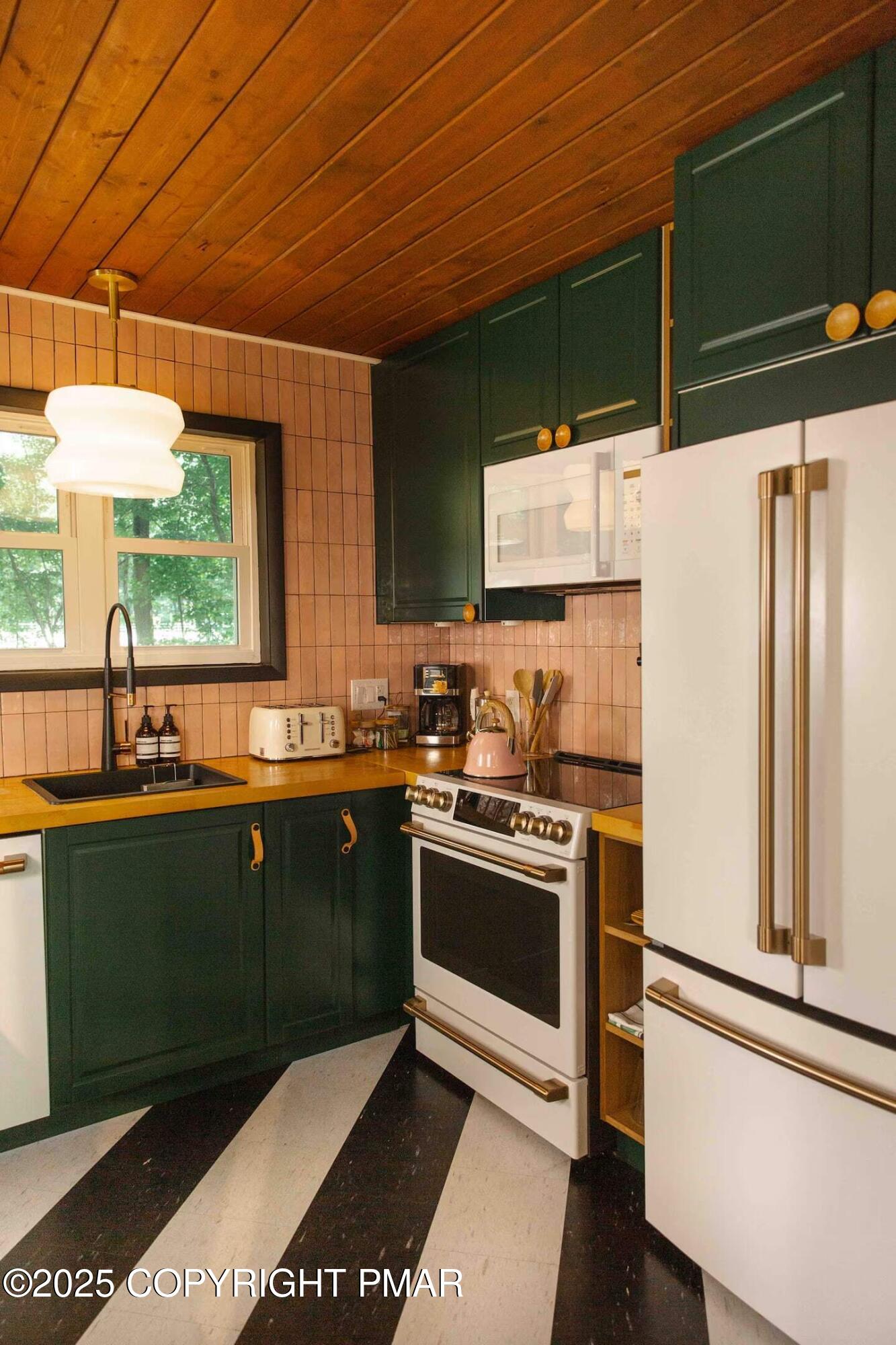 1242 Shadblow Road Pocono Summit, PA 18346 - Photo 22 of 46 a kitchen with stainless steel appliances granite countertop a refrigerator a sink dishwasher a stove and white cabinets with wooden floor