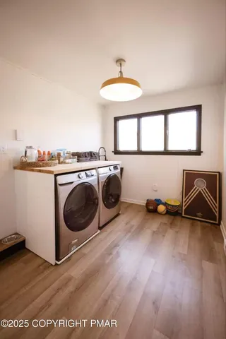 a view of a kitchen with a sink dishwasher and a fireplace with wooden floor
