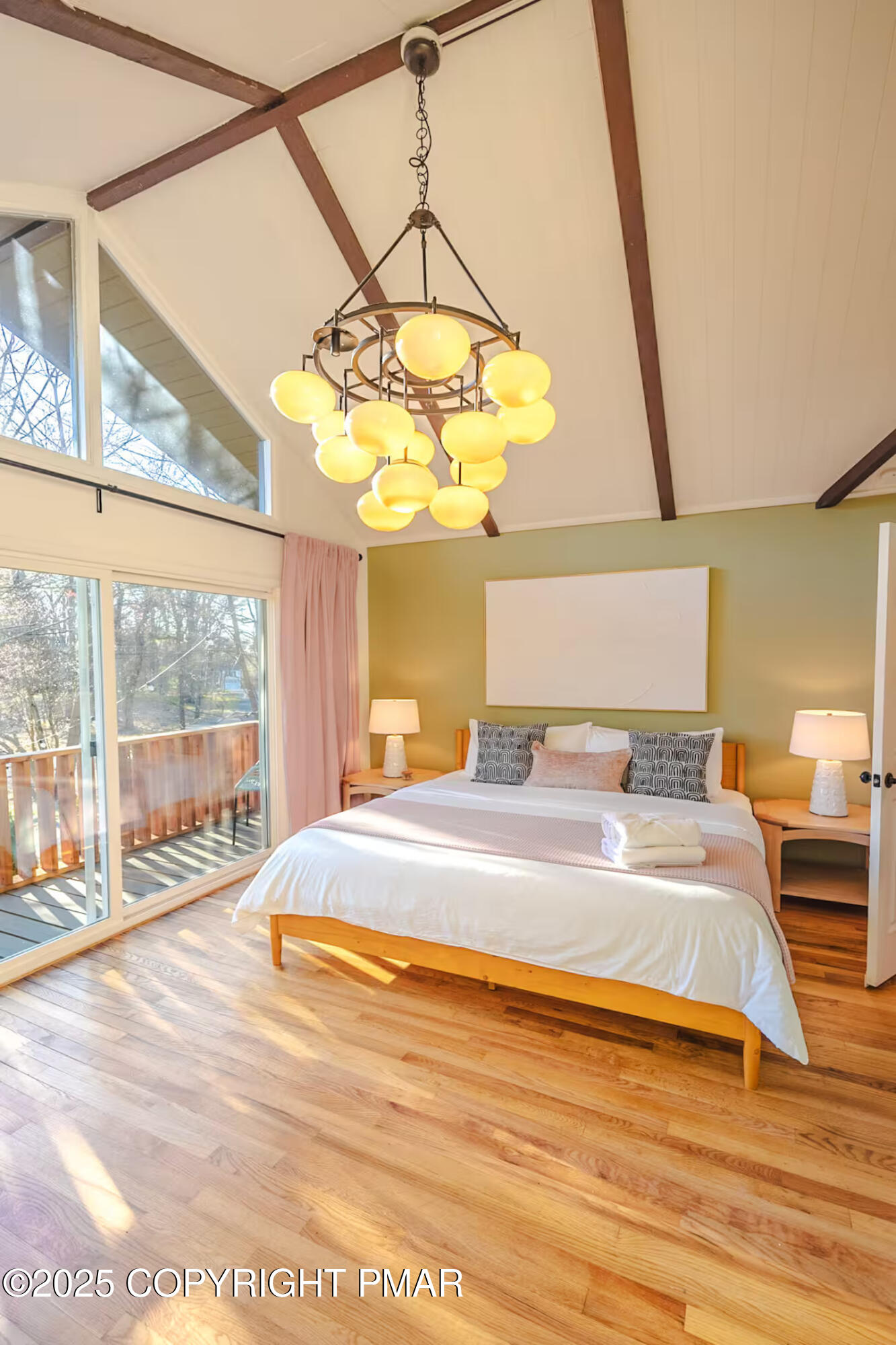 1242 Shadblow Road Pocono Summit, PA 18346 - Photo 26 of 46 a spacious bedroom with a bed and wooden floor