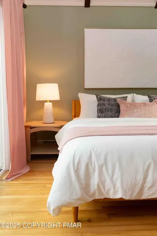 a bedroom with a bed and a night stand