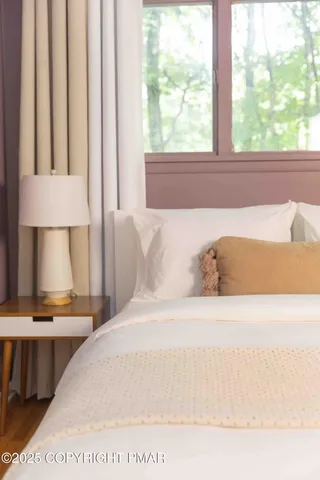 a bedroom with a bed and window