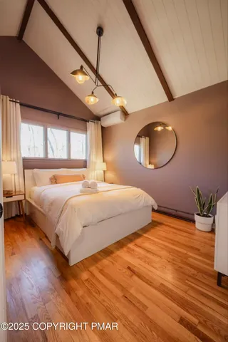 a bedroom with a large bed and a large window