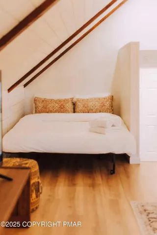 a bedroom with a bed and wall painting