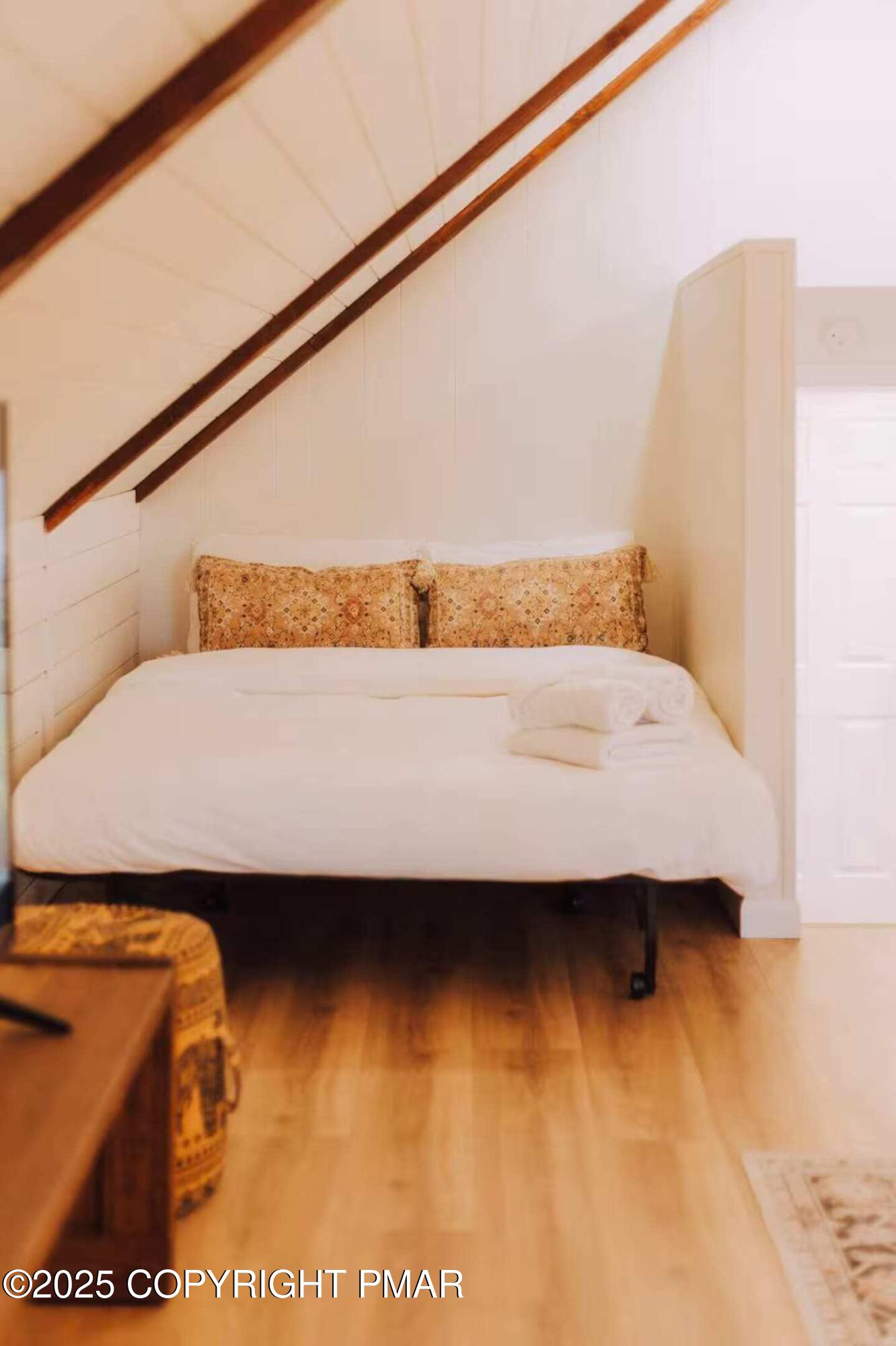 1242 Shadblow Road Pocono Summit, PA 18346 - Photo 34 of 46 a bedroom with a bed and wall painting