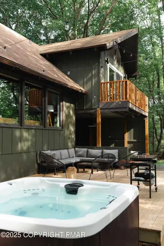 a view of a house with backyard tub and couches