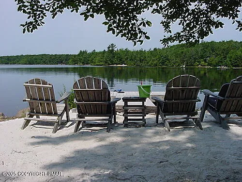 a view of a lake with a bench in roof deck