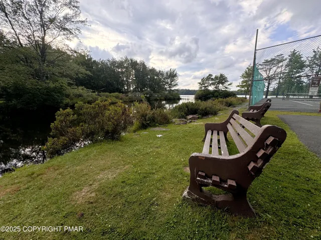 a wooden bench sitting in the middle of a lake