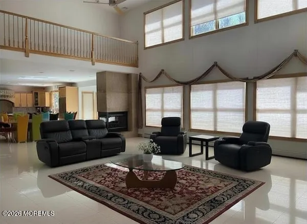 a living room with furniture a rug and a chandelier