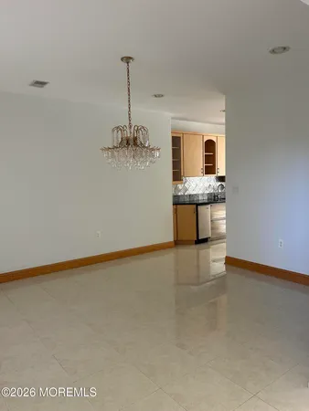 a kitchen with white cabinets and sink