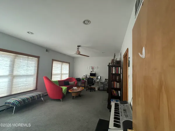 a spacious bedroom with a bed and a dresser