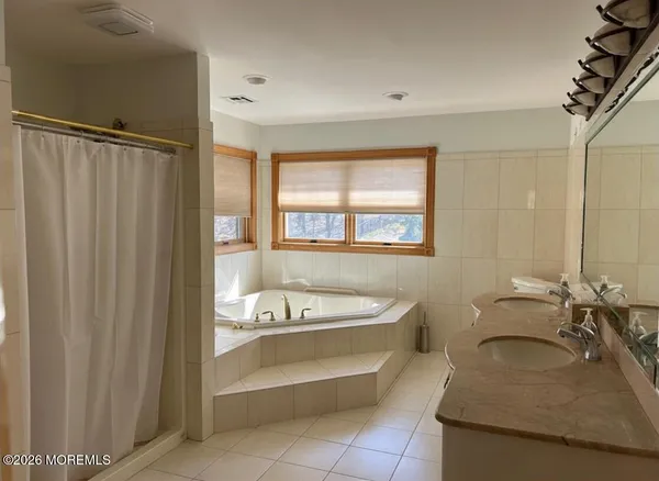 a bathroom with a shower and a sink