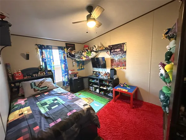 a bedroom with bed and a chandelier