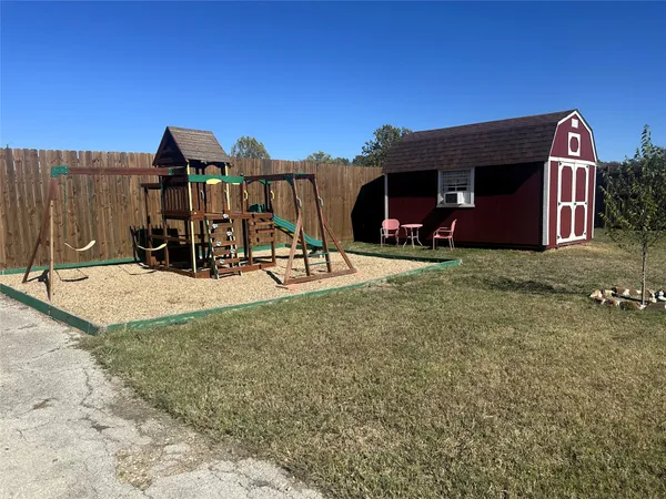 a view of a house with a yard and porch